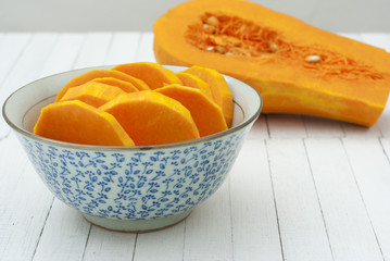 a bowl of sliced pumpkins on kitchen table
