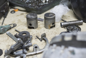 Motorcycle parts and tools on the desktop in garage