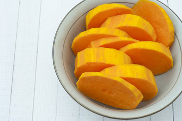 a bowl of sliced pumpkins on kitchen table