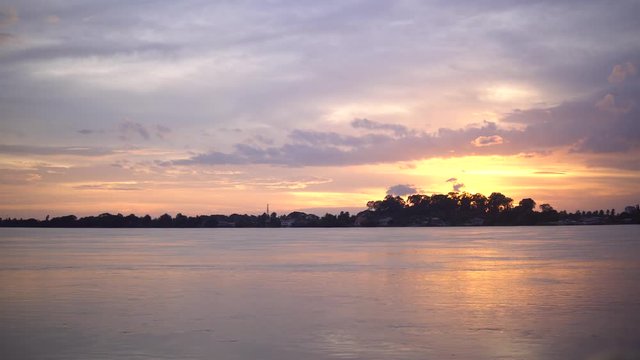 Natural landscape of Maekhong River is a muddy color during sunset at border line between Thailand and Lao,Asia. Shot image from Thailand side at Nongkhai province,Thailand.