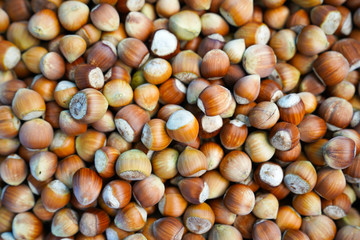 Stack of hazelnuts for sale at a farmer's market, selective focus.