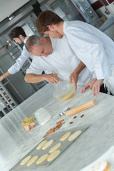Fototapeta premium apprentices in pastry learning with experienced chef