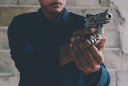 Businessman holding a gun to kill himself committed suicide because of despondent and despair in the office.