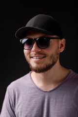 Obraz premium young bearded man in cap and sunglasses