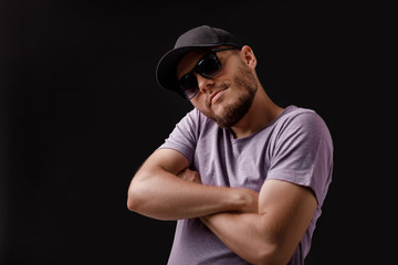 young bearded man in cap and sunglasses