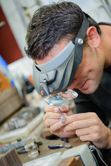 silver smith working with the low light