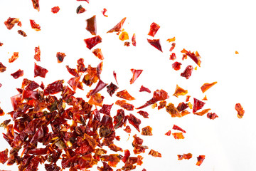 Pile crushed  dried red pepper flakes, on white background, top view, close up - Powered by Adobe