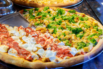 Pizza resting on a pizzeria counter the background is restaurant