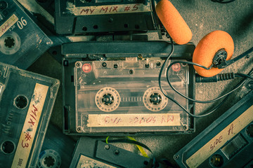 Old audio cassette with headphones and walkman