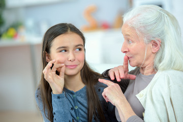 Little girl and grandma whispering secrets