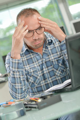businessman worried in front of his laptop