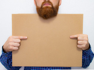 Funny bearded man with a cardboard sign in his hand