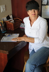 Mature female beauty working at her office desk at home.