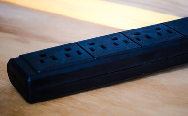 American class A 3-pronged mains power extension block for plugs placed on an office desk