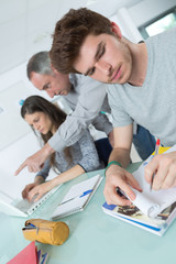 Obraz premium group of young students working in the class