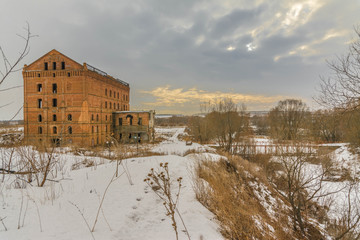 Ruined old mill on the river bank.