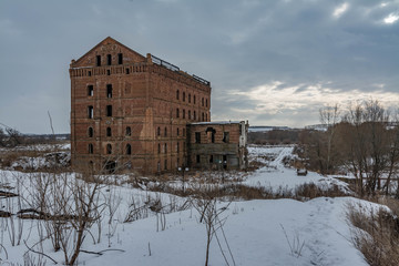 Fototapeta na wymiar Ruined old mill on the river bank.