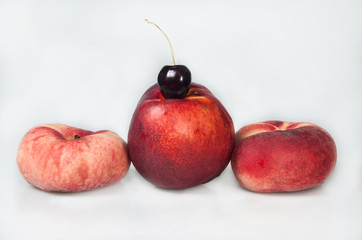 Compisition on white background with fruit. Peaches and cherry