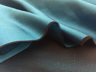 Woven texture of silk fabric or yarn turquois beige color changeable for background. Advertising...