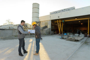 two male hardware store workers working in the yard