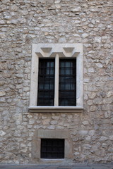 Old window surrounded by stones wall