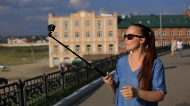 woman blogger shoots video on action camera for his blog on social networks.