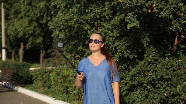 woman blogger shoots video on action camera for his blog on social networks.