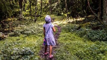 Fototapeta na wymiar Girl on a forest path.