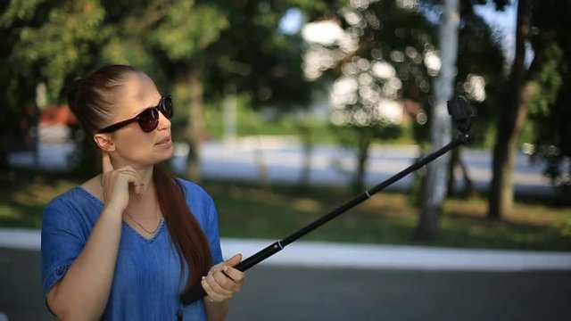 woman blogger shoots video on action camera for his blog on social networks.