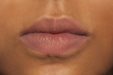 closeup of dark skinned female lips without makeup