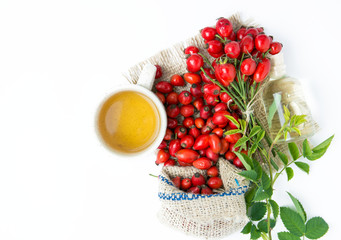 dog rose hips and herbal Tea on white background