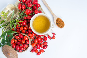 dog rose hips and herbal Tea on white background