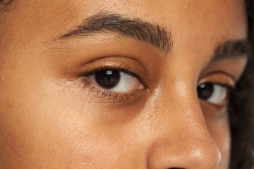 Fototapeta premium natural eyebrow and eye without makeup of dark skinned female