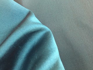 Woven texture of silk fabric or yarn turquois color changeable for background. Draped folded satin.