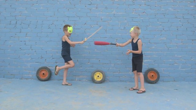 Children learn to fight with weapons in their hands. Woman shows combat techniques with swords. Boys dream of adventures, victories, travels, exploits. Conceptual preparation of spirit, patriotism