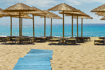 Sunbeds and umbrellas in a summer day at sandy Falassarna Beach, Crete