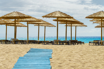 Sunbeds and umbrellas in a summer day at sandy Falassarna Beach, Crete