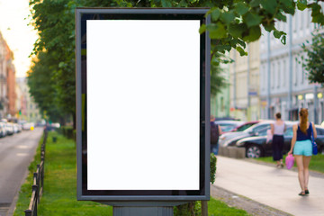 Blank mock up of vertical street poster billboard on city background.