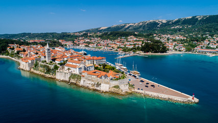 Fototapeta na wymiar Rab is a Croatian island in the Adriatic Sea, old town encircled by ancient walls. The town’s 4 prominent church bell towers include the Romanesque tower at the Cathedral Svete Marije (St. Mary)
