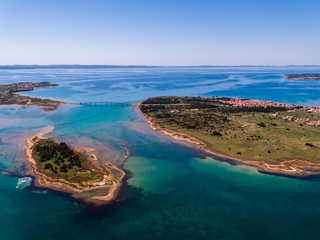 Aerial view of bridge to island Vir over the Adriatic sea with small island Viric in the foreground, Zadar county, Croatia