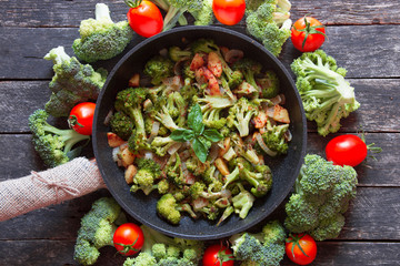 fresh broccoli and orange tomatoes, cooked broccoli with mushrooms, carrots and potatoes. organic and vegan food kitchen 