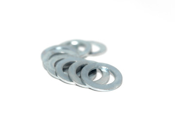 A few big industrial galvanized steel washers on white background
