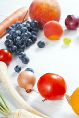 autumnal fruits and vegetables on white wooden table