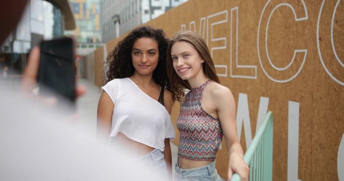 Teenagers posing for a smartphone photo 
