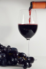 bunch of grapes with glass of wine