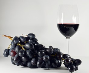 bunch of grapes with glass of wine