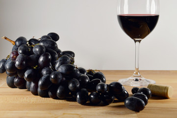bunch of grapes with glass of wine