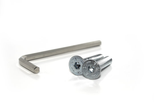 Single isolated Allen screw driver wrench with a couple of screws on white background