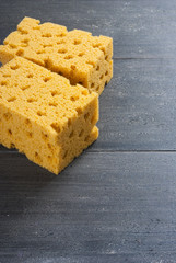 two foam sponges on dark wooden table
