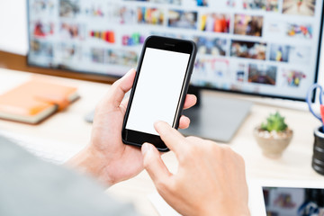 Man hands holding touching mobile smartphone blank white screen for mockup and app design display
